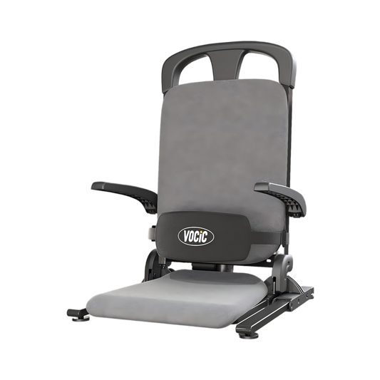 Grey sit-to-stand lift chair with padded seat and back, side handles, base controls